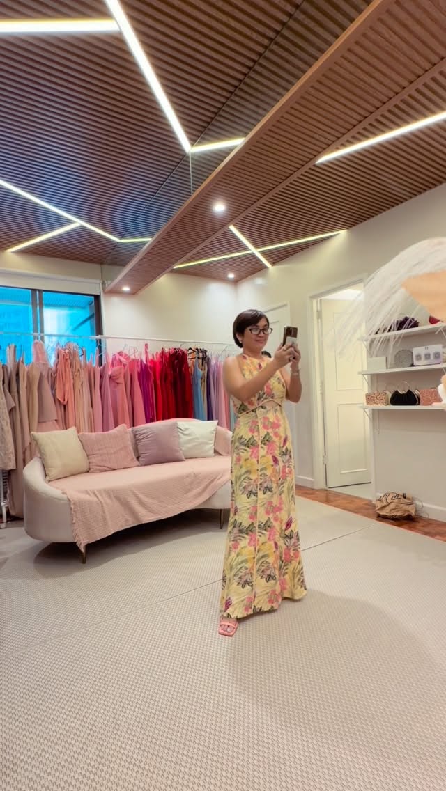 Dress Beyond Manila showroom interior — pink velvet sofa, dress racks with colourful gowns